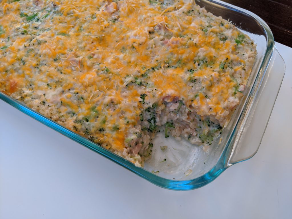 a glass baking dish of cooked broccoli chicken and rice casserole