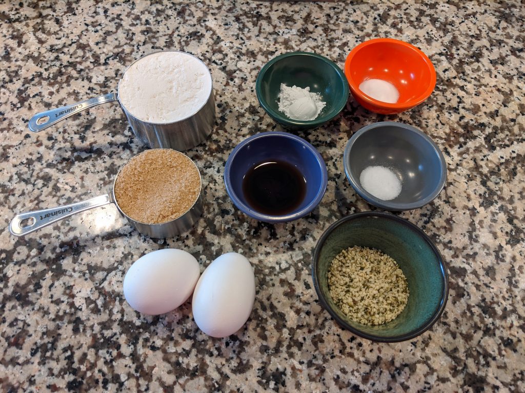 seven containers of measured ingredients and 2 eggs