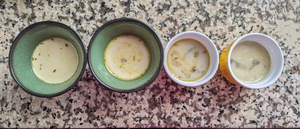 top down view of 4 small bowls of creamy soup