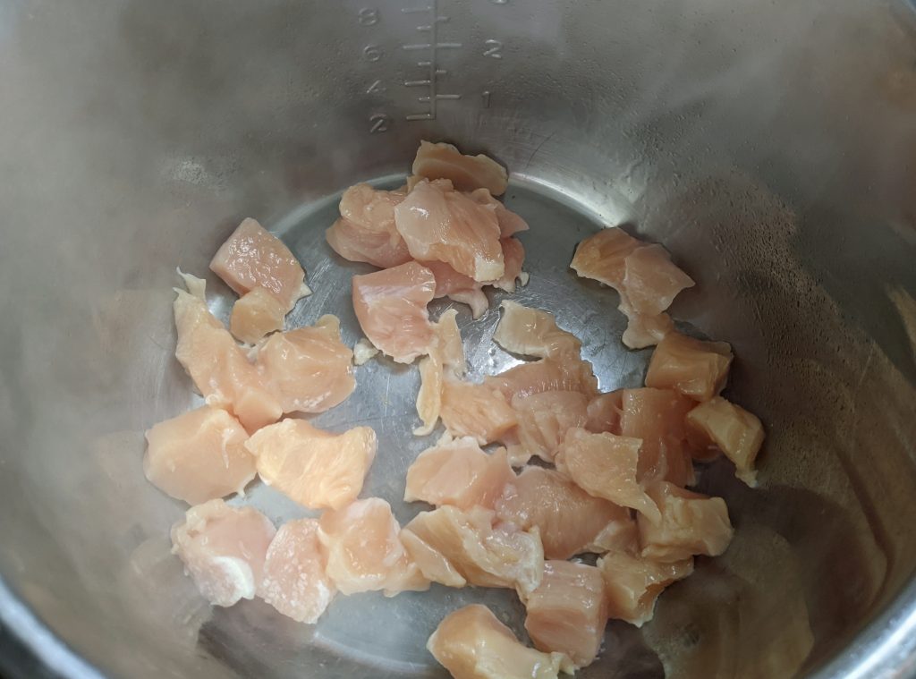 cut up chicken breast cooking in the instant pot