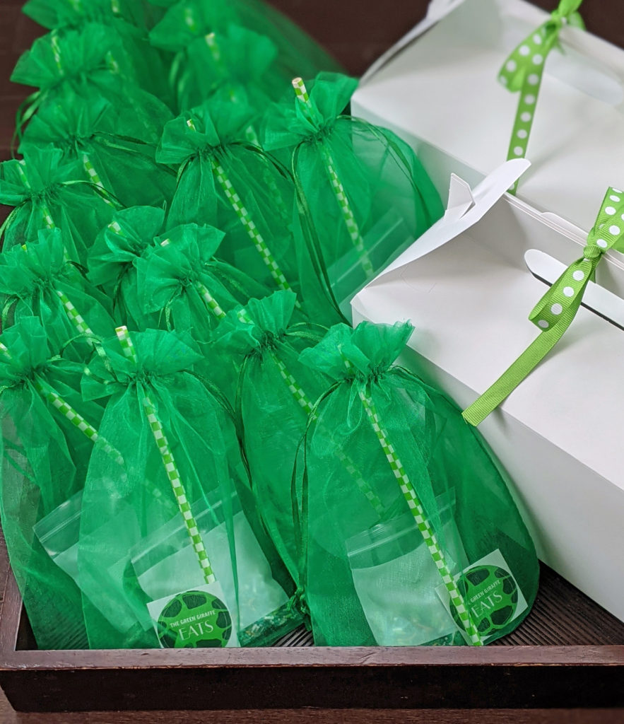 close up picture of green tulle bags filled with sprinkles and straws